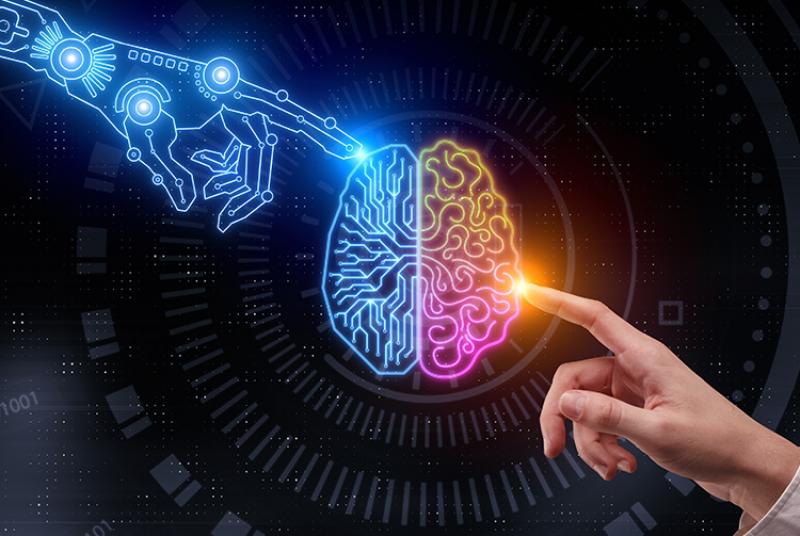 Graphic of a robotic hand is on the left side of the picture, and touching the left hemisphere of the brain which is in blue. On the right hand side of the picture, a human hand is pointing to the middle at the right hemisphere of the brain in rainbow.