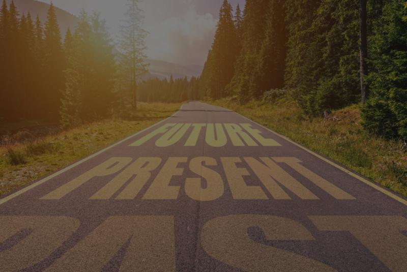 Driving on an empty road in the mountains to the Future passing Present and leaving behind the Past.