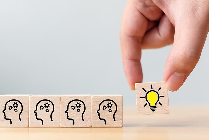 Small wooden tiles with an outline of a head with gears inside